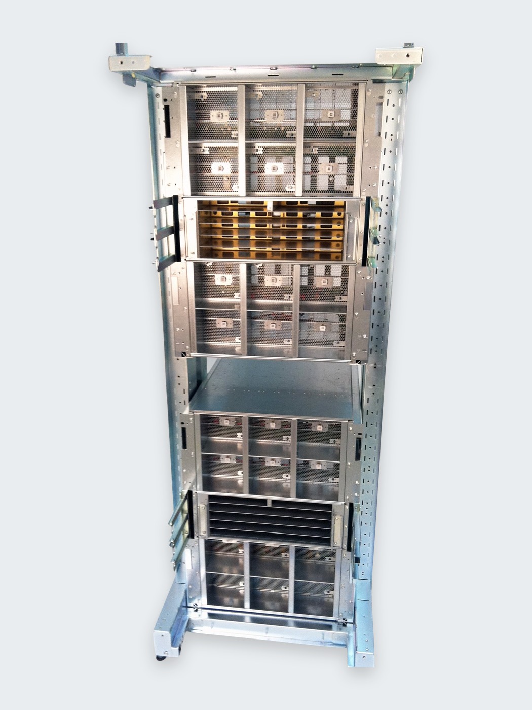 Open frame rack assembly populated with equipment modules